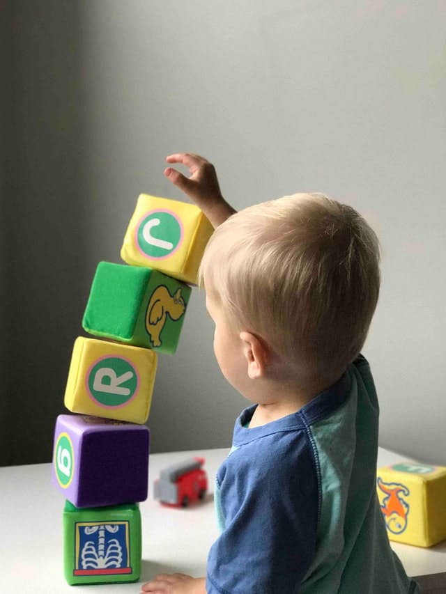 Kid stacking blocks