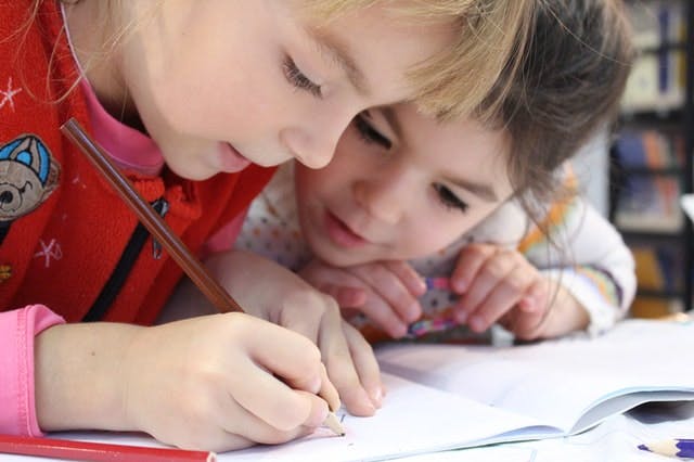 Children writing on workbook